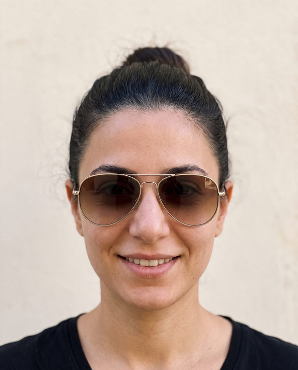 Oval face wearing aviator sunglasses